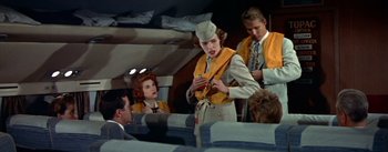 Movie still from “The High and the Mighty” (1954), directed by William A. Wellman – A group of men and women on a plane; Medium shot, Low angle