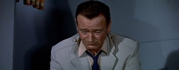 Movie still from “The High and the Mighty” (1954), directed by William A. Wellman – A person wearing a suit and a tie; Close Up shot, High angle