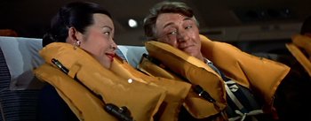 Movie still from “The High and the Mighty” (1954), directed by William A. Wellman – A man and a woman wearing life jackets; Close Up shot, High angle