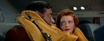 Movie still from “The High and the Mighty” (1954), directed by William A. Wellman – A man and a woman are looking at each other; Close Up shot, Low angle