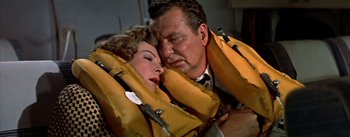 Movie still from “The High and the Mighty” (1954), directed by William A. Wellman – A man and a woman wearing life jackets; Close Up shot, Overhead angle