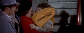 Movie still from “The High and the Mighty” (1954), directed by William A. Wellman – A woman holding a child wearing a life jacket; Close Up shot, High angle