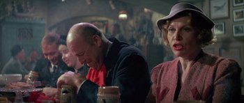 Movie still from “The Hindenburg” (1975), directed by Robert Wise – A man and a woman sitting at a table in a restaurant; Close Up shot, Over the shoulder angle