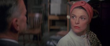 Movie still from “The Hindenburg” (1975), directed by Robert Wise – A person wearing a headscarf; Close Up shot, Over the shoulder angle