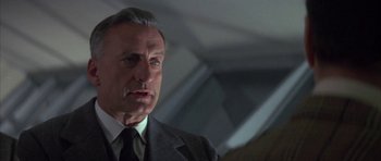 Movie still from “The Hindenburg” (1975), directed by Robert Wise – An older man wearing a suit and tie; Close Up shot, Low angle