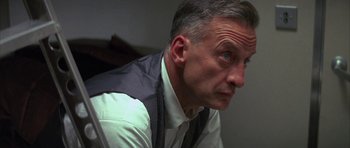 Movie still from “The Hindenburg” (1975), directed by Robert Wise – A person wearing a vest; Close Up shot, Low angle