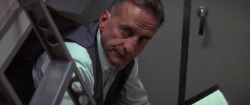 Movie still from “The Hindenburg” (1975), directed by Robert Wise – A person wearing a suit and tie; Close Up shot, Low angle