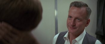 Movie still from “The Hindenburg” (1975), directed by Robert Wise – A person looking at another person in a mirror; Close Up shot, Over the shoulder angle