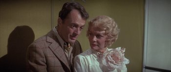 Movie still from “The Hindenburg” (1975), directed by Robert Wise – An older man standing next to an older woman; Close Up shot, Low angle