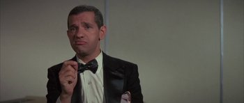 Movie still from “The Hindenburg” (1975), directed by Robert Wise – A man in a suit and bow tie; Close Up shot, Low angle