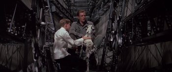 Movie still from “The Hindenburg” (1975), directed by Robert Wise – Two men and a dalmatian dog in an airplane cockpit; Medium shot, Low angle