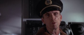 Movie still from “The Hindenburg” (1975), directed by Robert Wise – A person wearing a hat; Close Up shot, Low angle