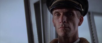 Movie still from “The Hindenburg” (1975), directed by Robert Wise – A person wearing a hat; Close Up shot, Low angle