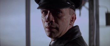 Movie still from “The Hindenburg” (1975), directed by Robert Wise – A person wearing a hat; Close Up shot, Low angle