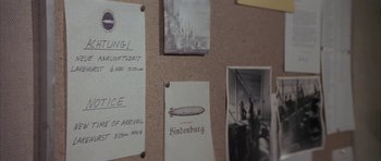 A bunch of old photos are hanging on the wall