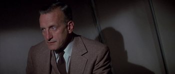 Movie still from “The Hindenburg” (1975), directed by Robert Wise – A person wearing a suit and tie; Close Up shot, Low angle