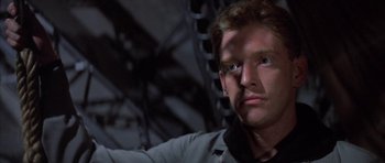 Movie still from “The Hindenburg” (1975), directed by Robert Wise – A person looking at the camera; Close Up shot, Low angle