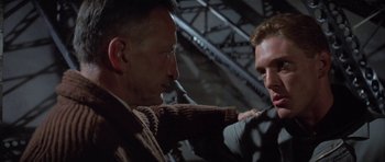 Movie still from “The Hindenburg” (1975), directed by Robert Wise – Two men are fighting each other in a warehouse; Close Up shot, Over the shoulder angle