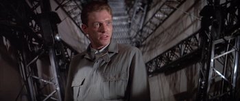 Movie still from “The Hindenburg” (1975), directed by Robert Wise – A person standing in a room; Close Up shot, Low angle