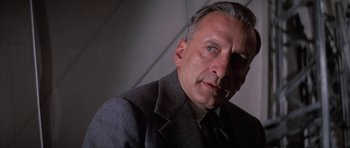 Movie still from “The Hindenburg” (1975), directed by Robert Wise – An older man wearing a suit and tie; Close Up shot, Low angle