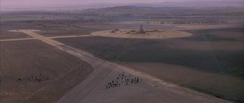 Movie still from “The Hindenburg” (1975), directed by Robert Wise – An aerial view of people standing in a field; Extreme Wide shot, High angle