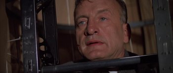 Movie still from “The Hindenburg” (1975), directed by Robert Wise – A person looking at a mirror; Close Up shot, Low angle