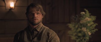 Movie still from “The Homesman” (2014), directed by Tommy Lee Jones – A person wearing a vest; Close Up shot, Over the shoulder angle