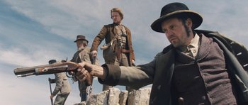 Movie still from “The Homesman” (2014), directed by Tommy Lee Jones – A group of men standing next to each other on top of a hill; Medium shot, Low angle