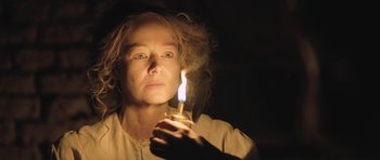 Movie still from “The Homesman” (2014), directed by Tommy Lee Jones – A woman is holding a lit candle in the dark; Close Up shot, Low angle