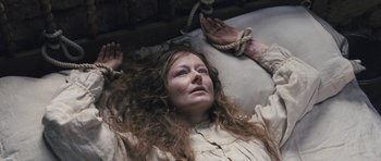 Movie still from “The Homesman” (2014), directed by Tommy Lee Jones – A woman laying on the ground with a rope around her neck; Close Up shot, High angle