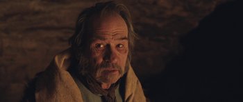 Movie still from “The Homesman” (2014), directed by Tommy Lee Jones – An old man with a beard and a mustache; Close Up shot, Over the shoulder angle
