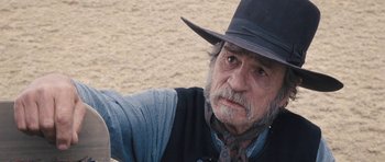 Movie still from “The Homesman” (2014), directed by Tommy Lee Jones – An older man in a cowboy hat and vest; Close Up shot, Low angle