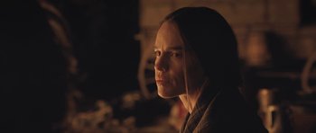 Movie still from “The Homesman” (2014), directed by Tommy Lee Jones – A woman with long brown hair is looking into the distance; Close Up shot, Over the shoulder angle