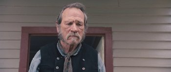 Movie still from “The Homesman” (2014), directed by Tommy Lee Jones – An older man with a beard and a tie; Close Up shot, Over the shoulder angle
