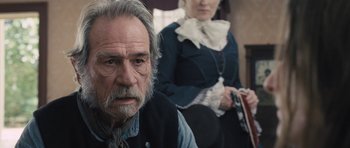 Movie still from “The Homesman” (2014), directed by Tommy Lee Jones – An older man and a younger woman sitting on a bench; Close Up shot, Over the shoulder angle