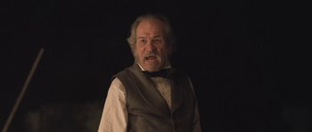 Movie still from “The Homesman” (2014), directed by Tommy Lee Jones – An old man in a vest and a bow tie; Close Up shot, Low angle