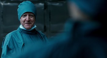 Movie still from “The Host” (2006), directed by Bong Joon Ho – A man wearing a blue surgical gown and a blue surgical cap; Close Up shot, Over the shoulder angle