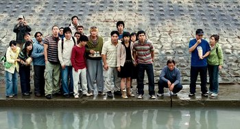 Movie still from “The Host” (2006), directed by Bong Joon Ho – A group of people standing next to a body of water; Wide shot, High angle