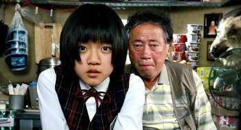 Movie still from “The Host” (2006), directed by Bong Joon Ho – An older man sitting next to a young girl; Close Up shot, Over the shoulder angle