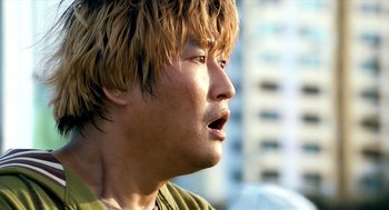 Movie still from “The Host” (2006), directed by Bong Joon Ho – A person with long brown hair; Close Up shot, Low angle