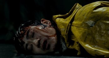 Movie still from “The Host” (2006), directed by Bong Joon Ho – A young boy is laying on the ground covered in blood; Close Up shot, High angle