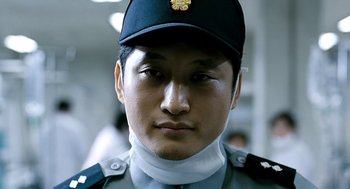 Movie still from “The Host” (2006), directed by Bong Joon Ho – A person wearing a uniform; Close Up shot, Low angle