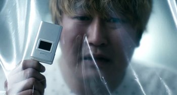 Movie still from “The Host” (2006), directed by Bong Joon Ho – A man holding a cell phone in front of his face; Extreme Close Up shot, Low angle