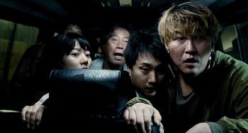 Movie still from “The Host” (2006), directed by Bong Joon Ho – A group of people in the back of a vehicle; Close Up shot, High angle