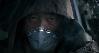 Movie still from “The Host” (2006), directed by Bong Joon Ho – A man wearing a face mask while looking out a window; Close Up shot, Low angle