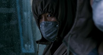 Movie still from “The Host” (2006), directed by Bong Joon Ho – A person wearing a face mask looking out of a window; Close Up shot, Low angle