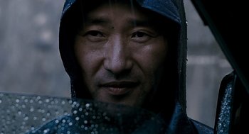 Movie still from “The Host” (2006), directed by Bong Joon Ho – A person wearing a raincoat; Close Up shot, Low angle