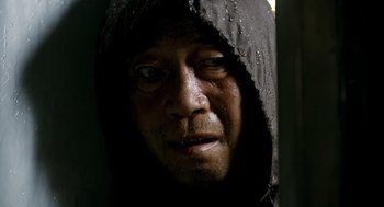 Movie still from “The Host” (2006), directed by Bong Joon Ho – A person wearing a hooded jacket; Close Up shot, Low angle