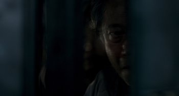 Movie still from “The Host” (2006), directed by Bong Joon Ho – A man is looking out a window at night; Extreme Close Up shot, Over the shoulder angle