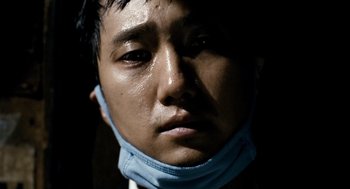 Movie still from “The Host” (2006), directed by Bong Joon Ho – A person wearing a face mask; Extreme Close Up shot, Low angle